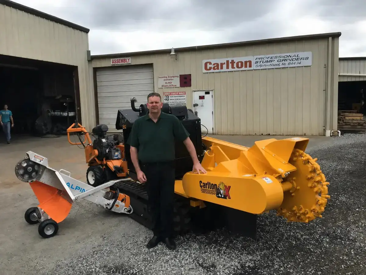 Dave, owner-operator of Auckland Stump Removal, with a tracked stump grinder and a portable Alpine stump grinder
