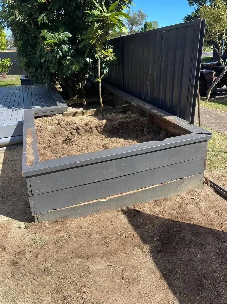 Raised garden bed with the stump ground out and the soil levelled