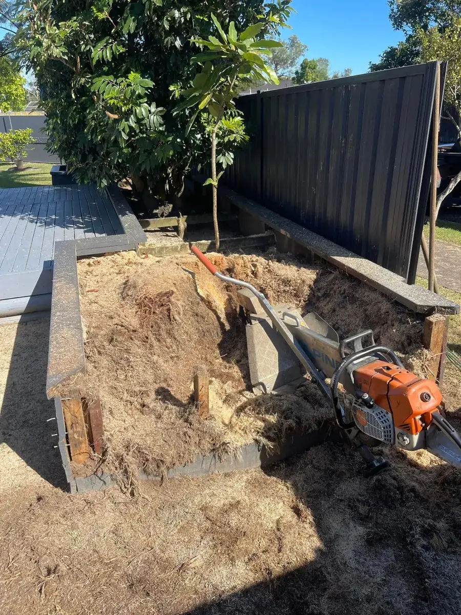 Portable Alpine stump grinder working inside the raised garden bed